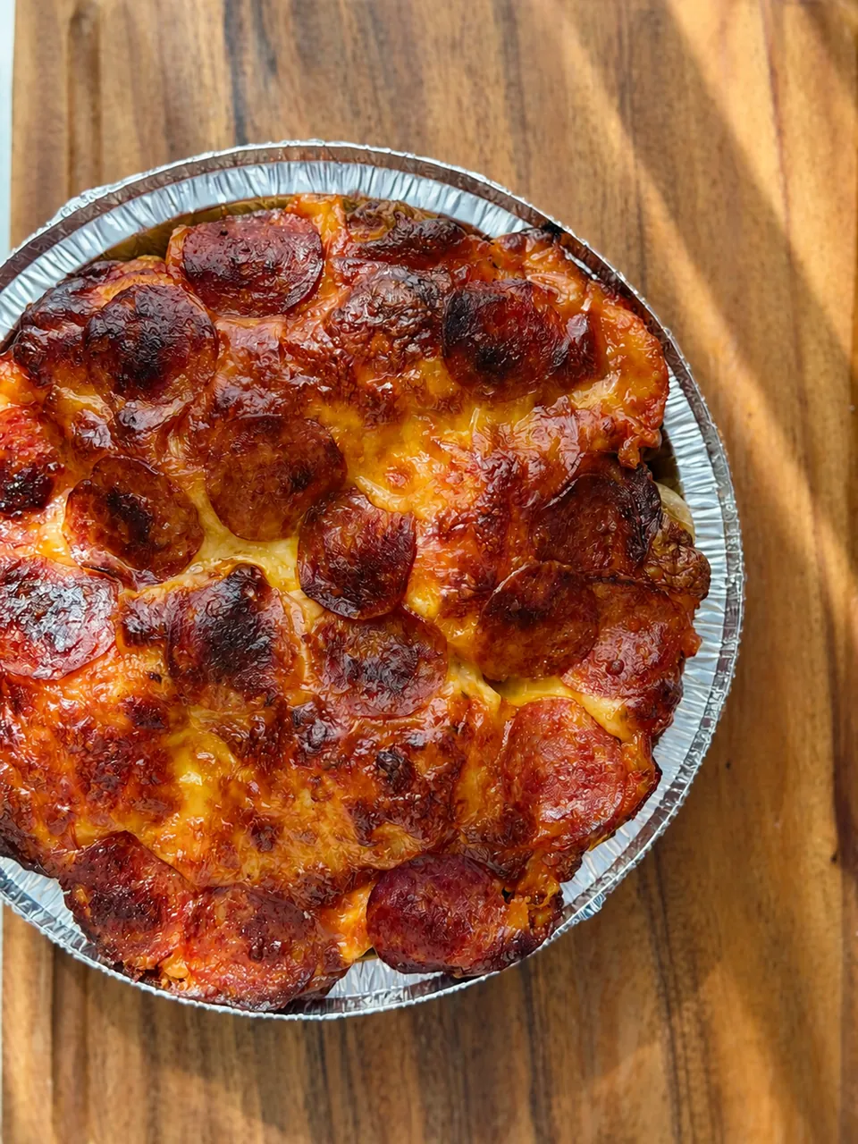 Sourdough focaccia pizza with roasted tomatoes on a cooling rack