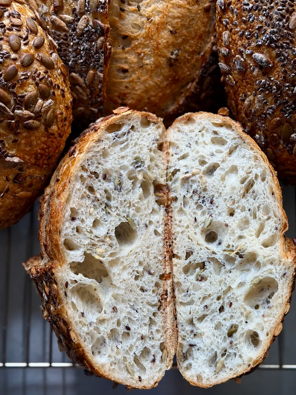 Multiseed sourdough loaf, sliced to show open crumb and seed crust
